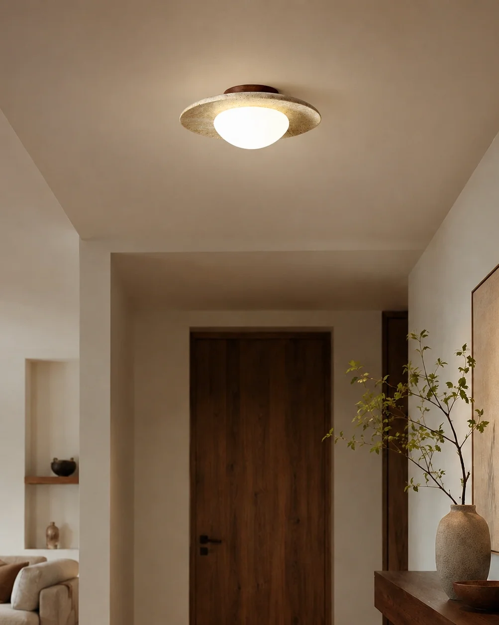 The Eclipse travertine and walnut flush mount ceiling light lighting a calm hallway