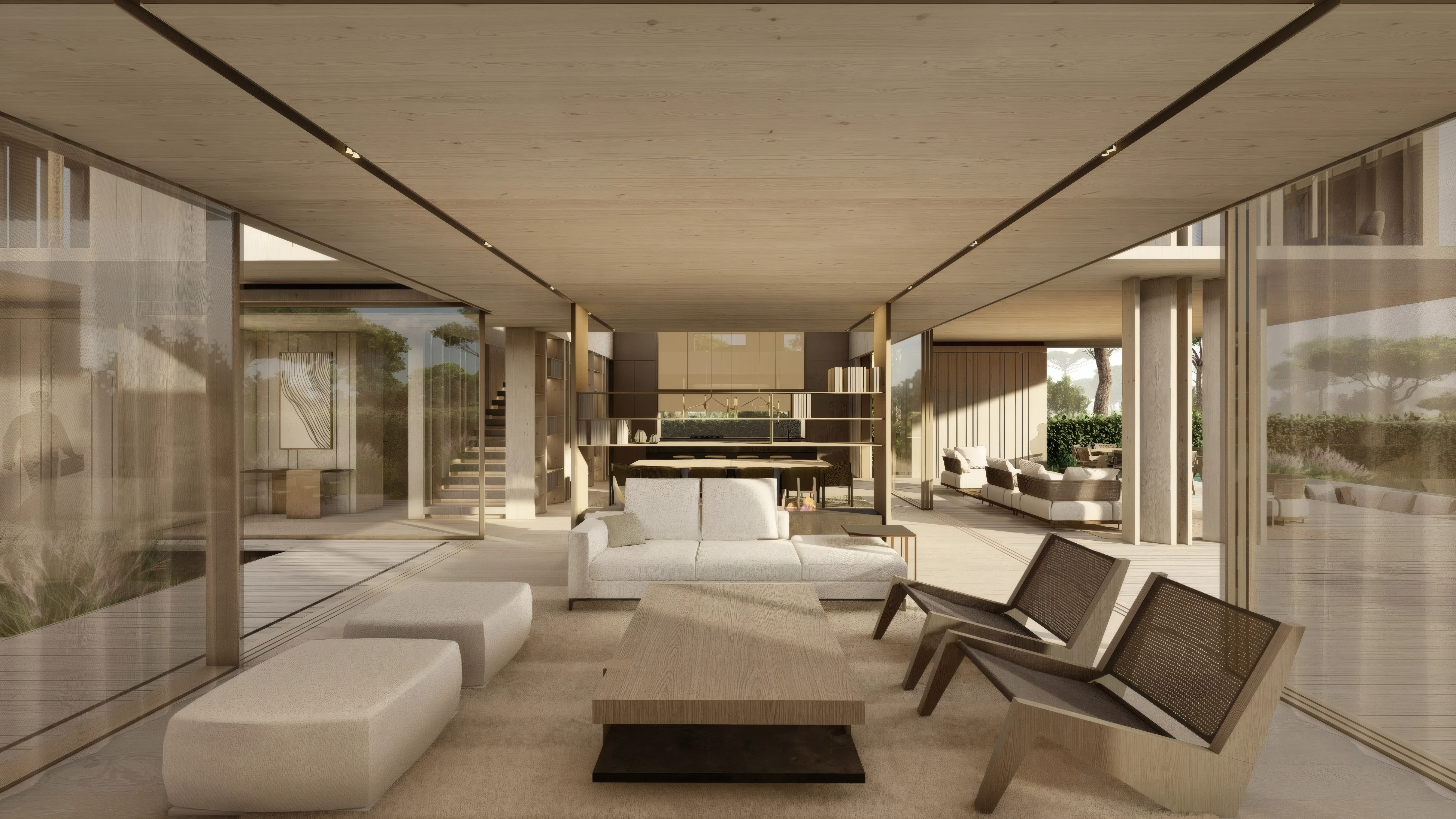 Long open-plan living space lit by recessed ceiling lights, with sofas and a dining area beyond