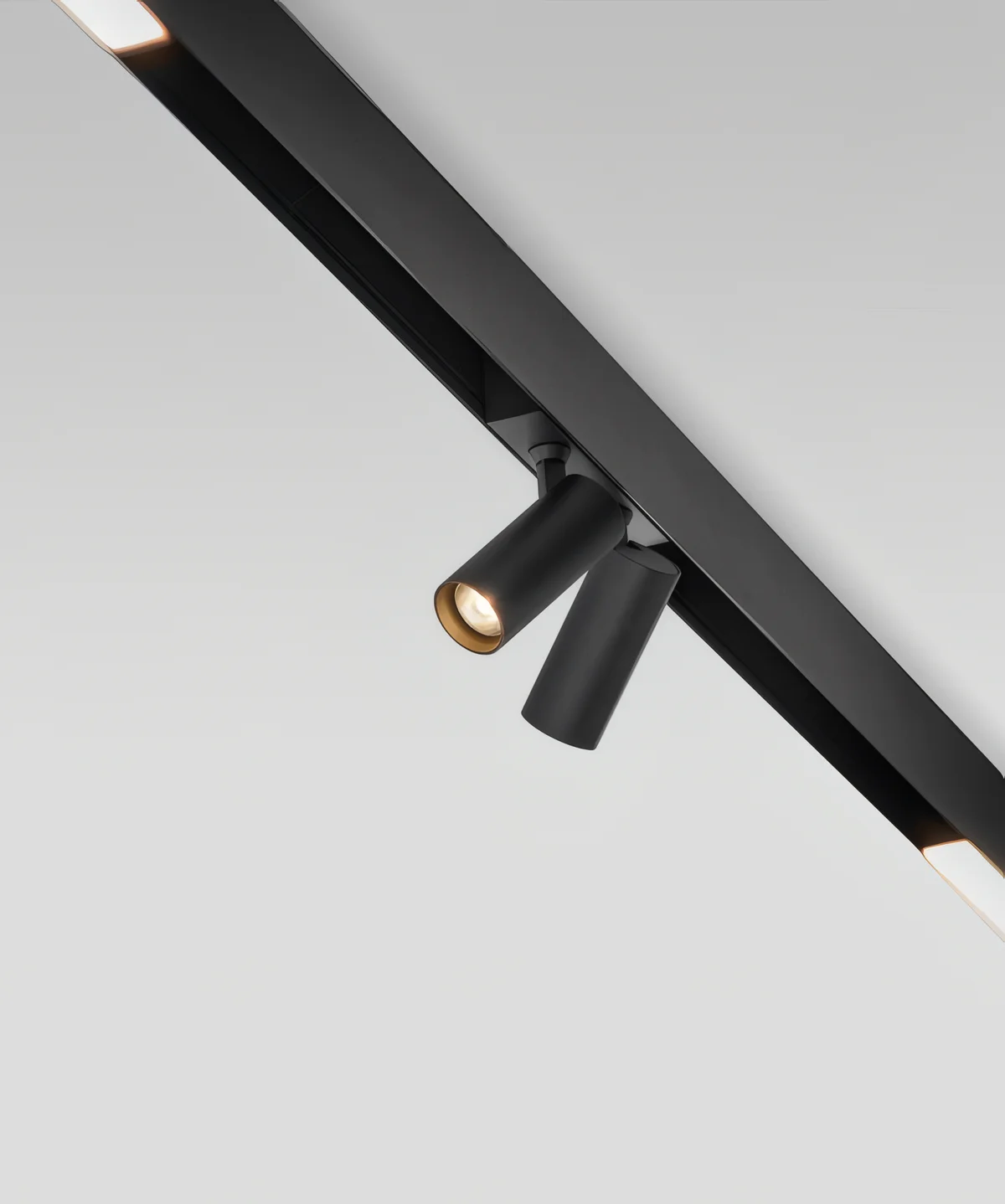 Surface-mounted magnetic track fixed to a ceiling with two adjustable spots